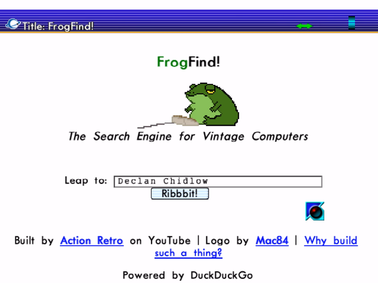 A white webpage reading 'FrogFind! The Search Engine for Vintage Computers' with a picture of a green frog with a computer mouse. At the top of the page is the browser interface, which is striped shades of blue and shows the PlanetWeb logo beside the current page title. The cursor is blue and glossy.