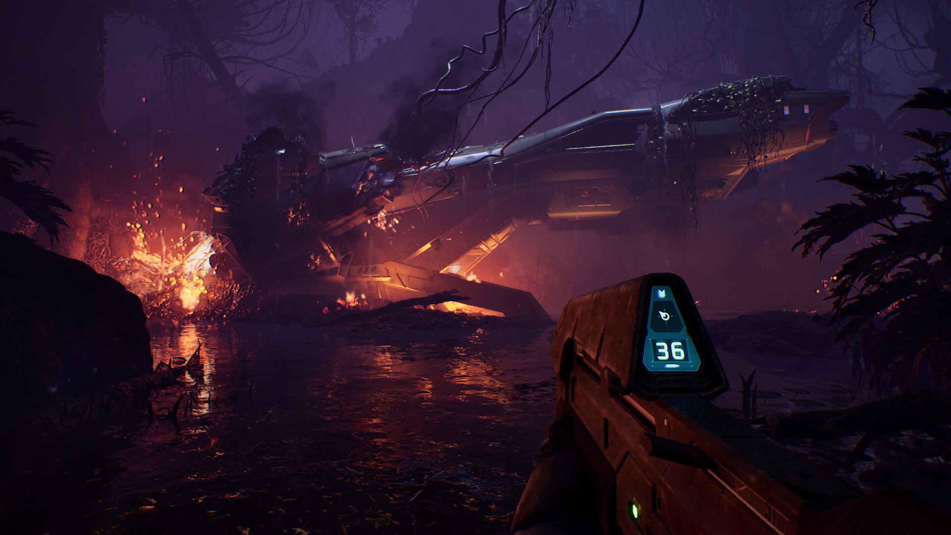 A crashed Pelican ship alight with orange flames which are reflected by the wet, marshy ground and illuminate the trees in the dark purple haze of a swamp.